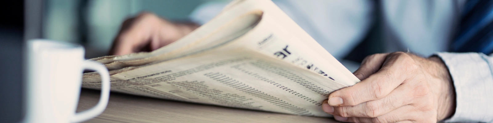 holding a newspaper